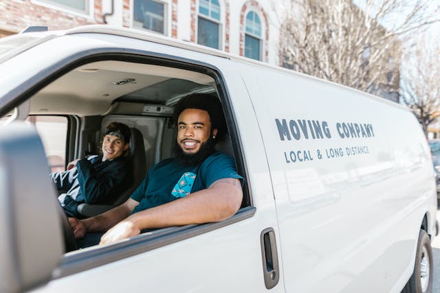 Moving company workers in a van. 
