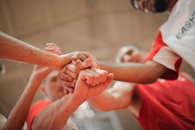 A group of people stacking hands together.