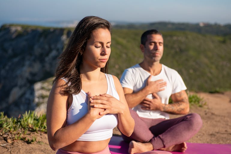 a couple meditating